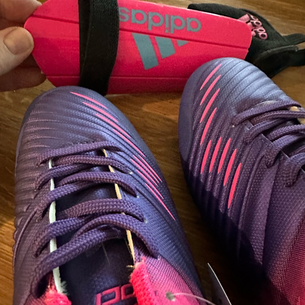 Brand NWT pink/purple soccer cleats and set of new shin guards